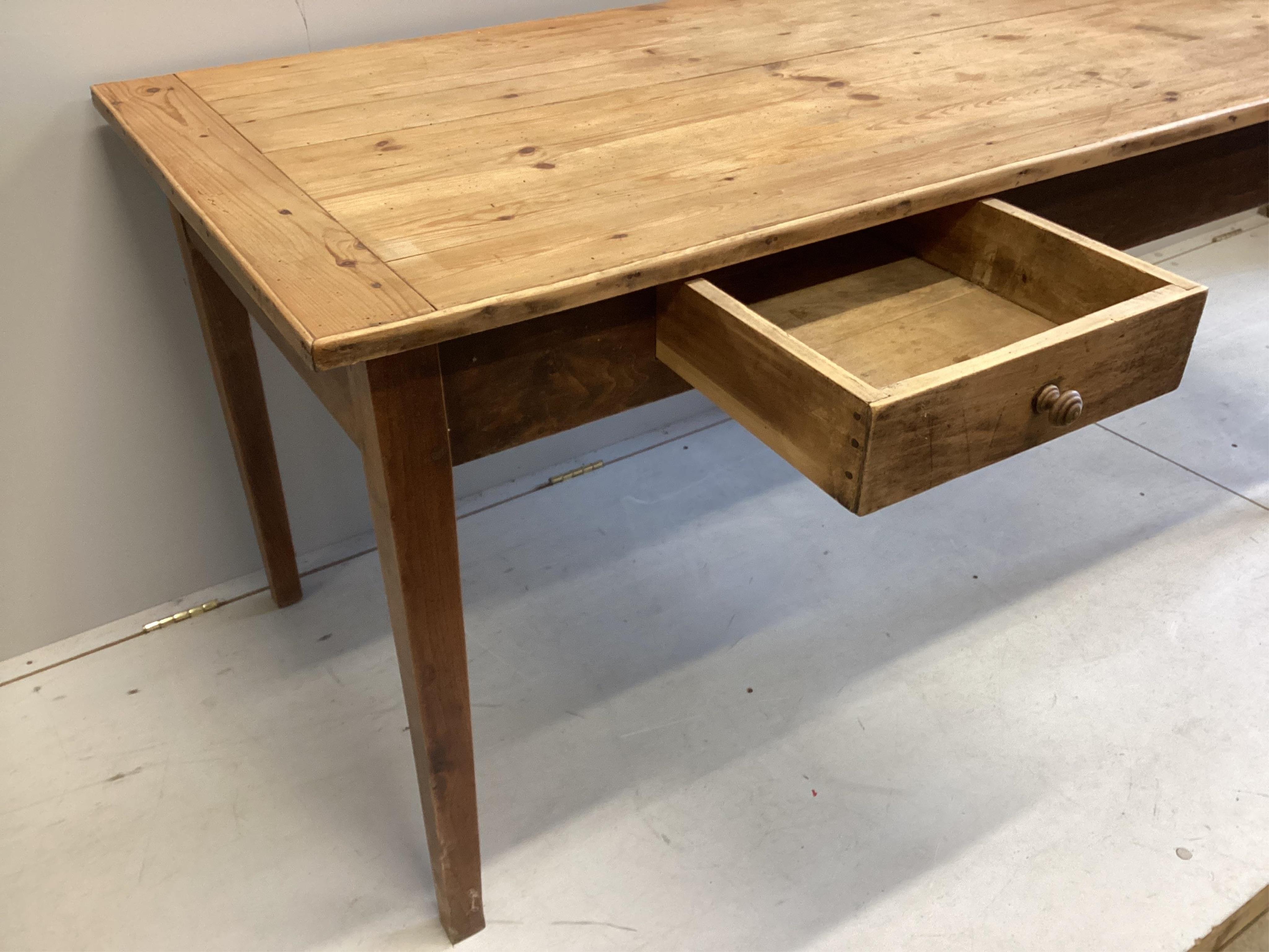 A 19h century French rectangular pine and fruitwood two drawer kitchen table, width 172cm, depth 78cm, height 76cm. Condition - fair, top with slightly opened joints and has traces of old worm.